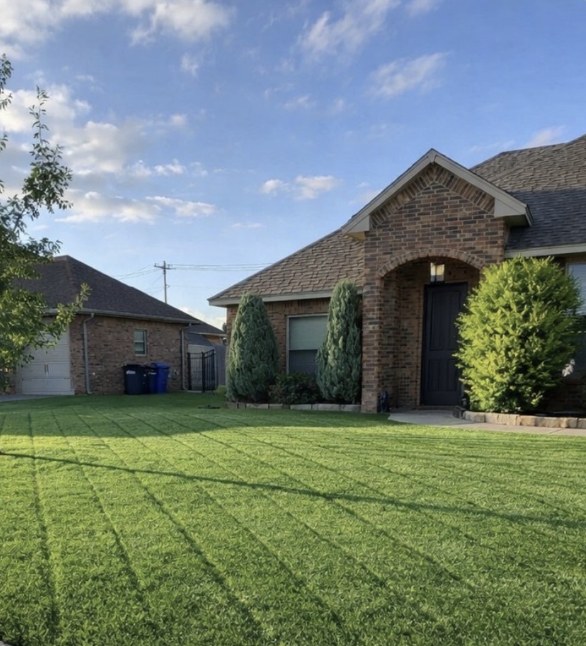 Front lawn freshly mowed with straight mowing stripes
